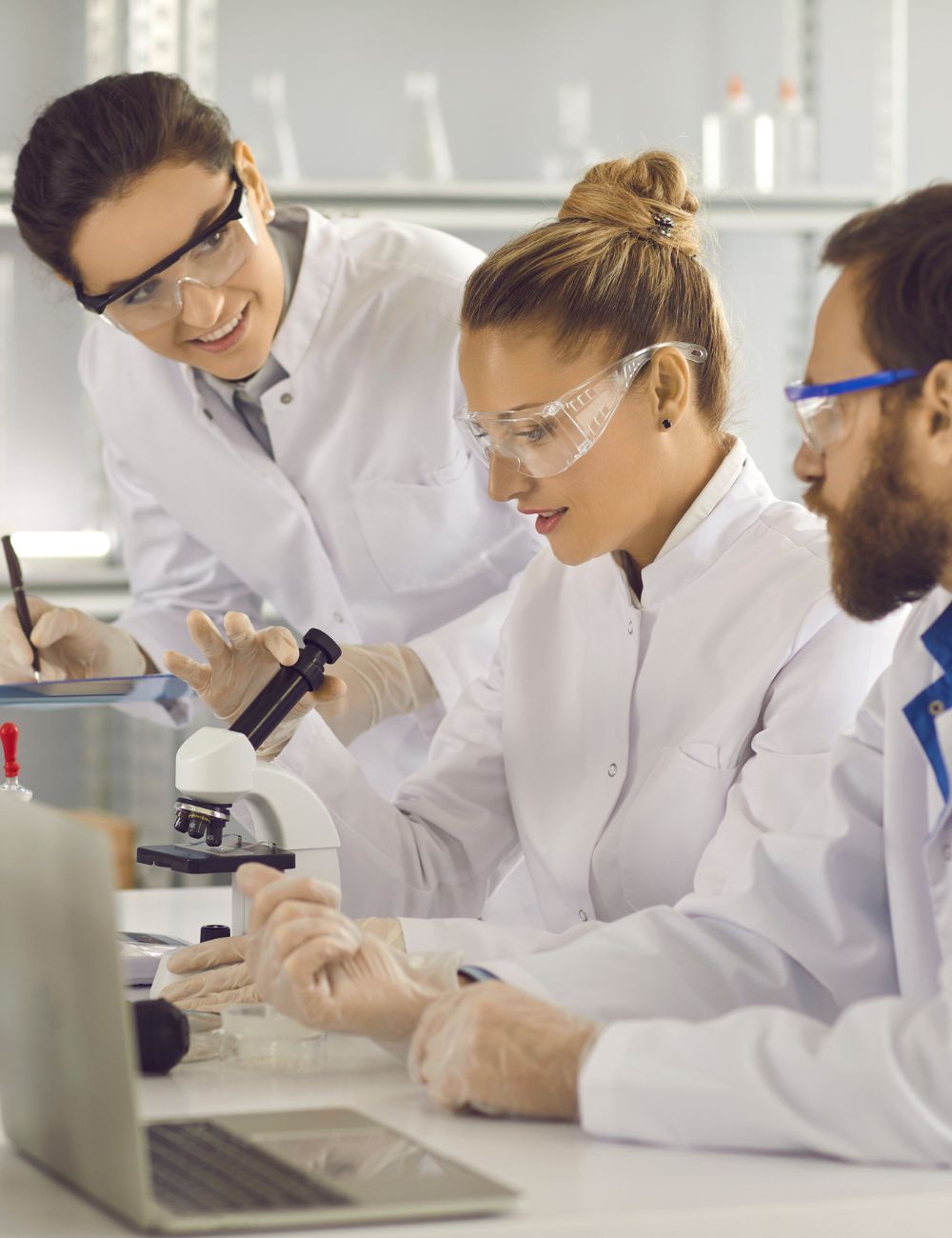 Medical scientists work together at a bench.