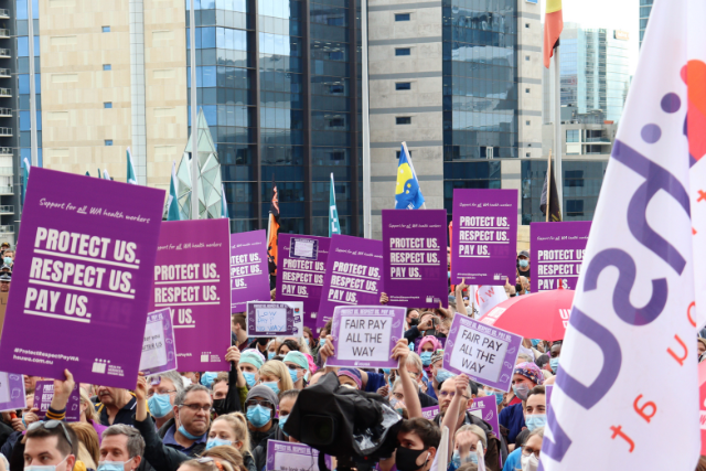 HSUWA Members gathered at parliament house with signs and flags, demanding fair pay.