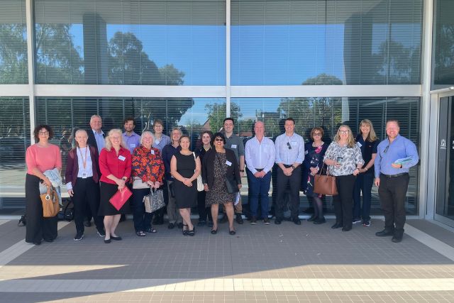 A group of HSUWA Members and Health Professionals stand together outside Dumas House, ready to attend the Allied Health Round Table.