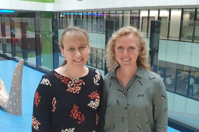Music Therapists Louise and Karen stand together, smiling at Perth Children's Hospital.