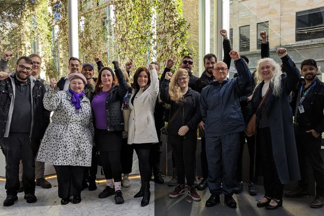 A group of Members at HSS with their fists in the air.
